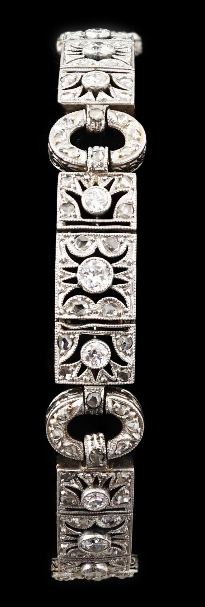 A 1920's pierced 18ct white gold and millegrain set round and rose cut diamond cluster bracelet